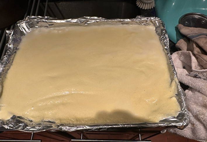 Creme anglaise spread on a baking sheet.